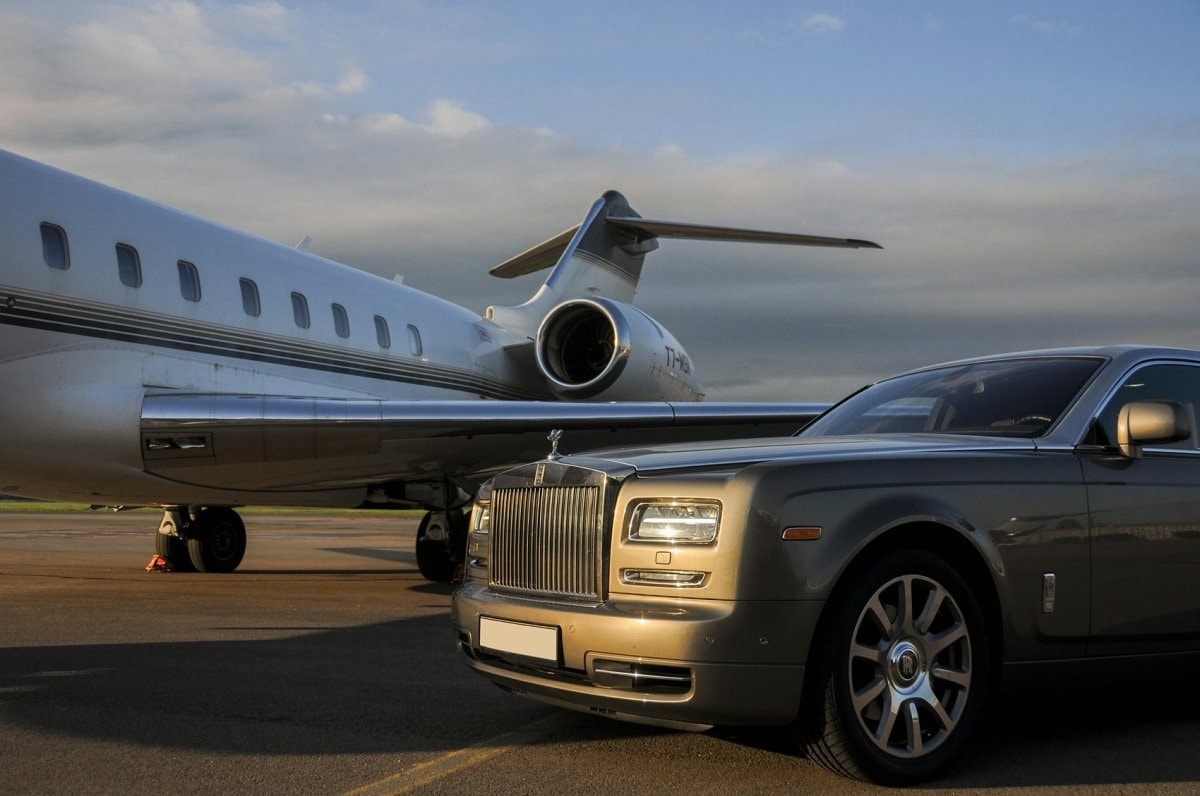 Black luxury sedan in front of a Dubai high-rise